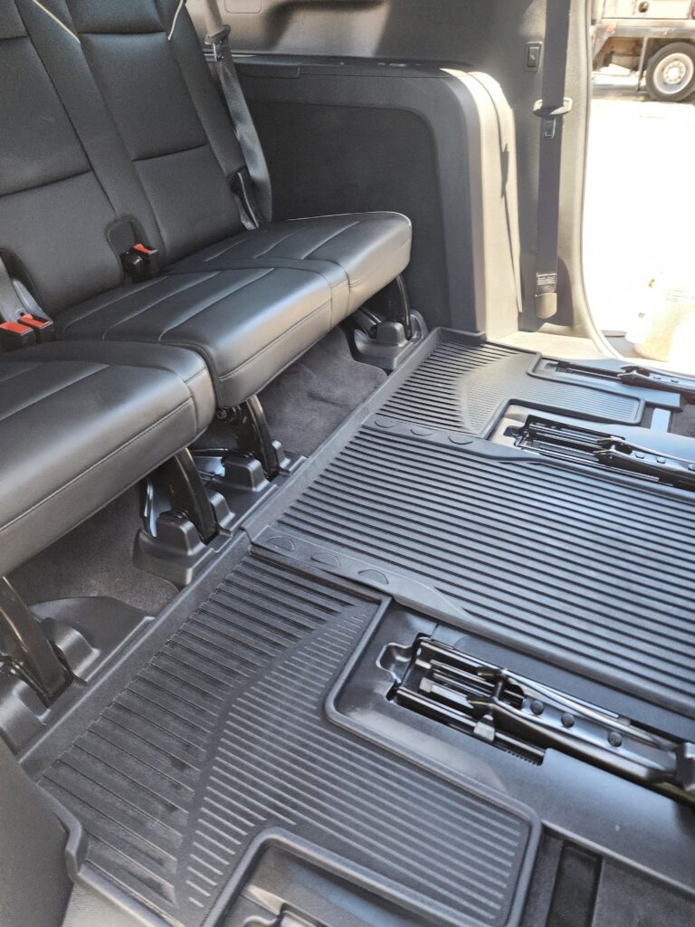 A truck with the seats folded down and the floor in place.