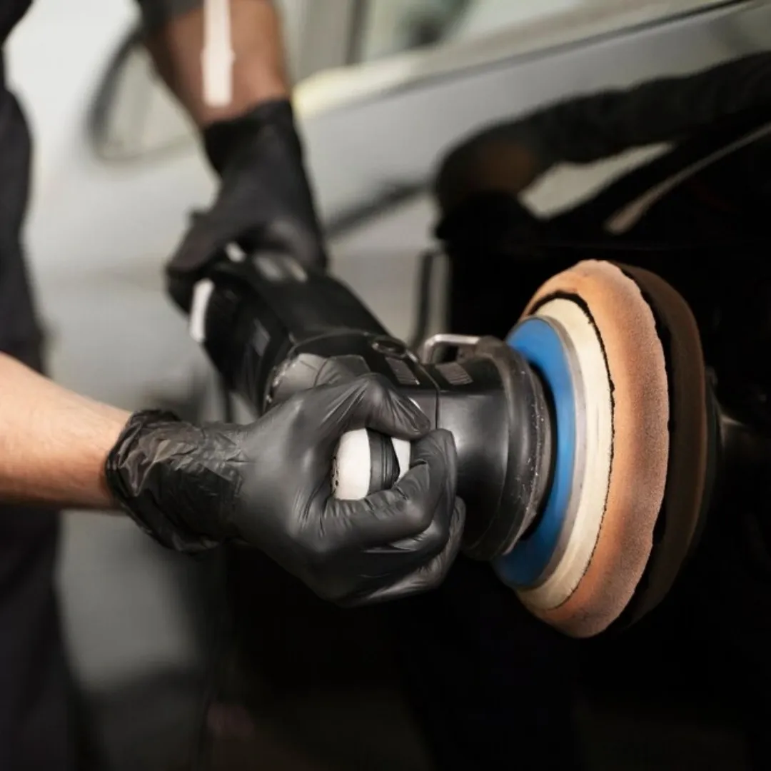 Buffing light scratches off of the clear coat to prepare the surface of the car for ceramic coating.