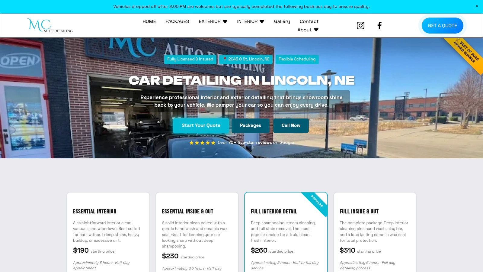 A detailer meticulously cleaning the interior of a car with a brush and vacuum.