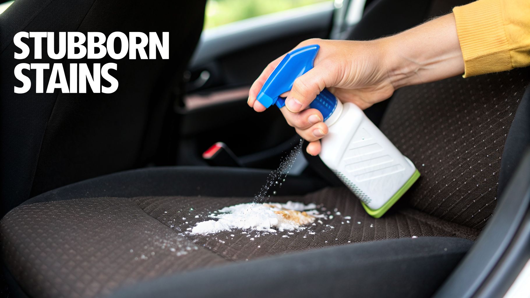 A person sprays a cleaning solution on a car seat to remove stubborn brown and white powder stains.