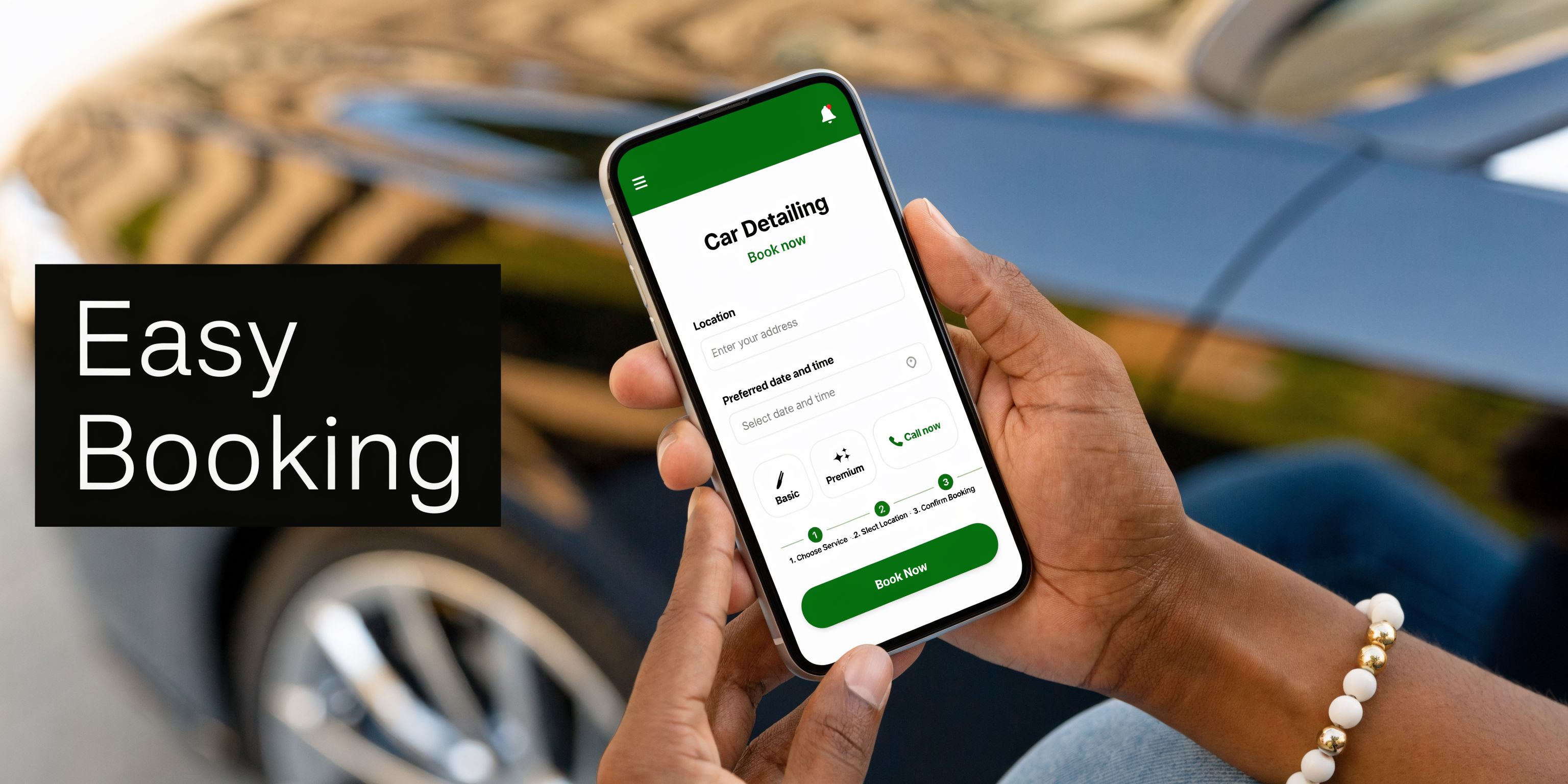 A person holding a smartphone displaying an easy online booking app for professional auto car detailing services.