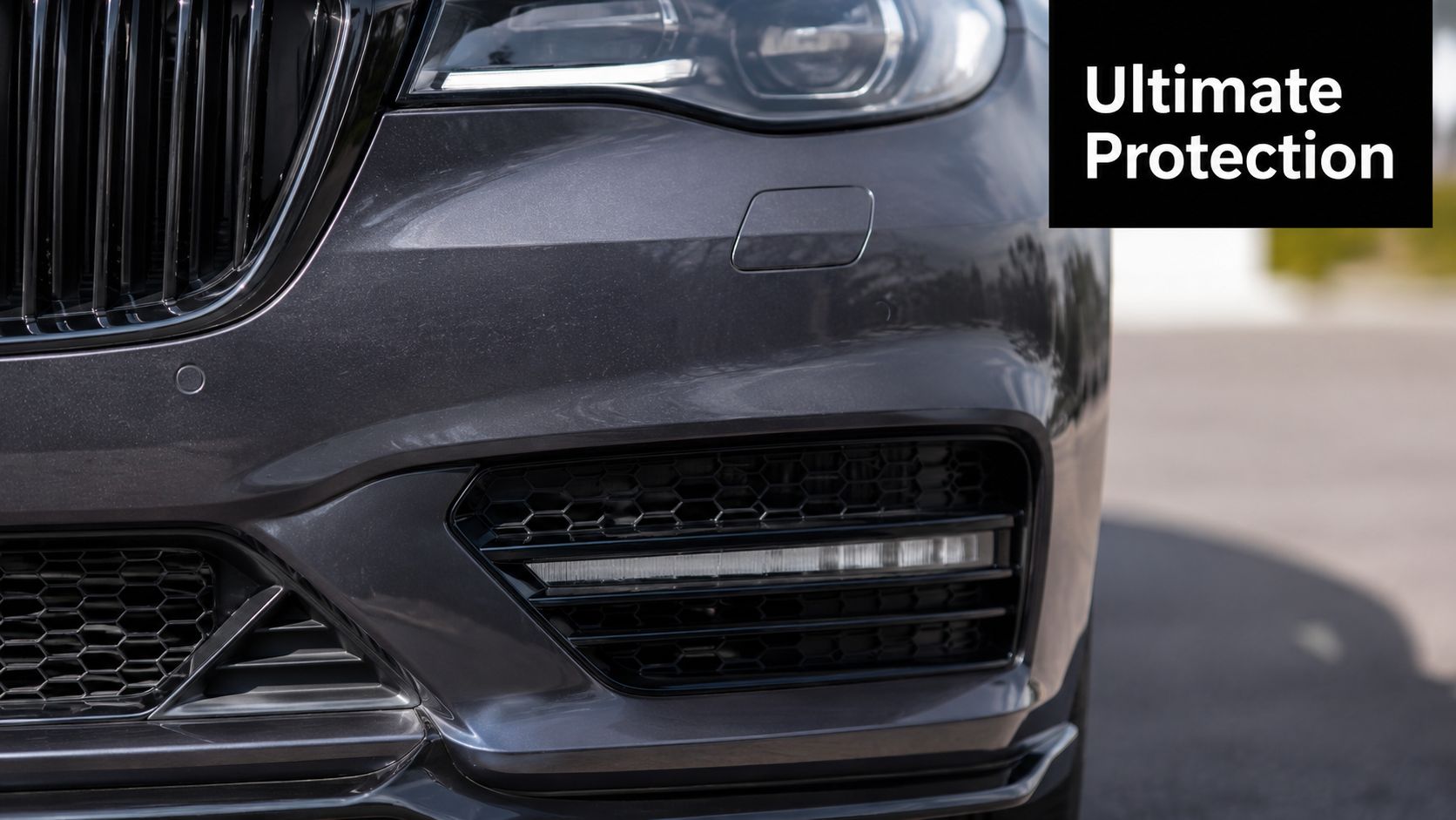Close-up of a sleek dark grey BMW front bumper highlighting paint protection film application benefits.